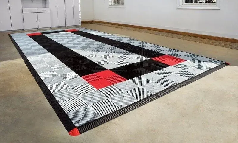 a black , white and red garage floor tile system .