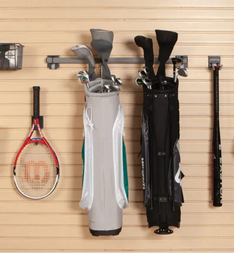 a golf bag is hanging on a wall next to a tennis racquet and a baseball bat