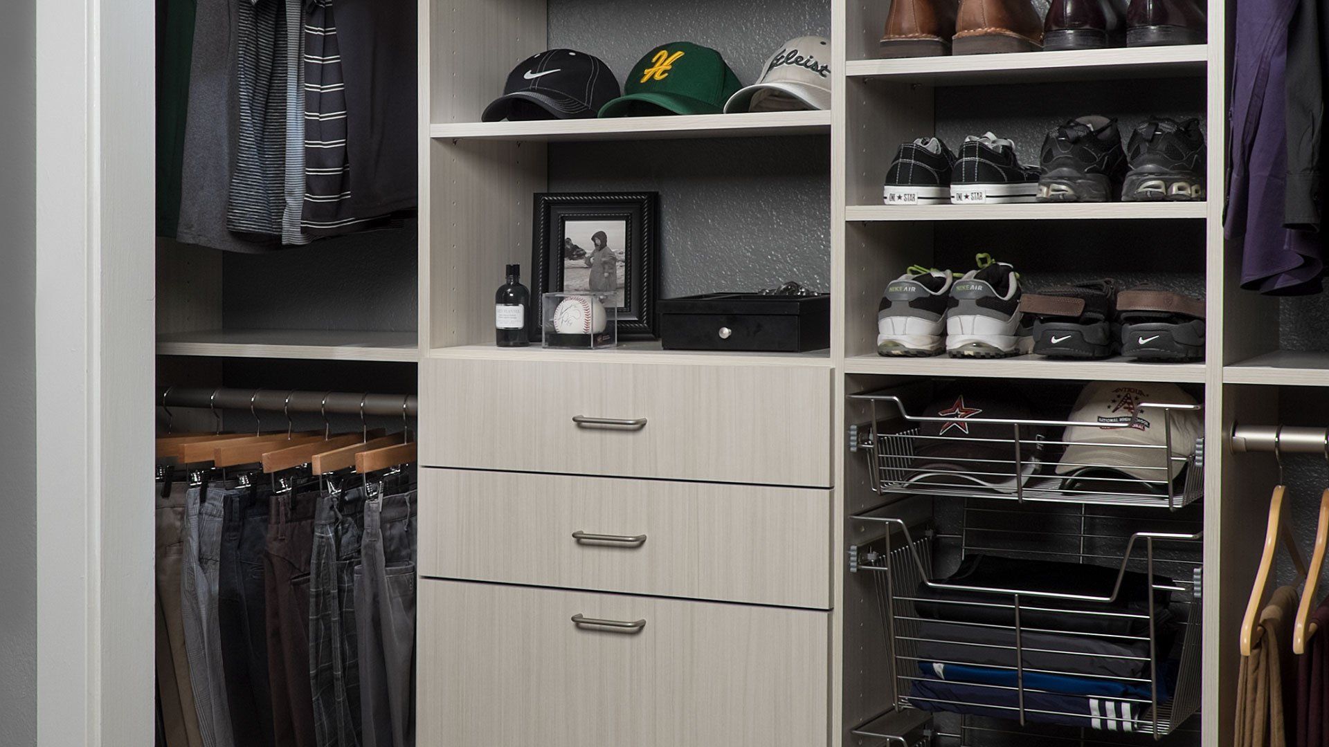 a reach in closet filled with lots of clothes and shoes .