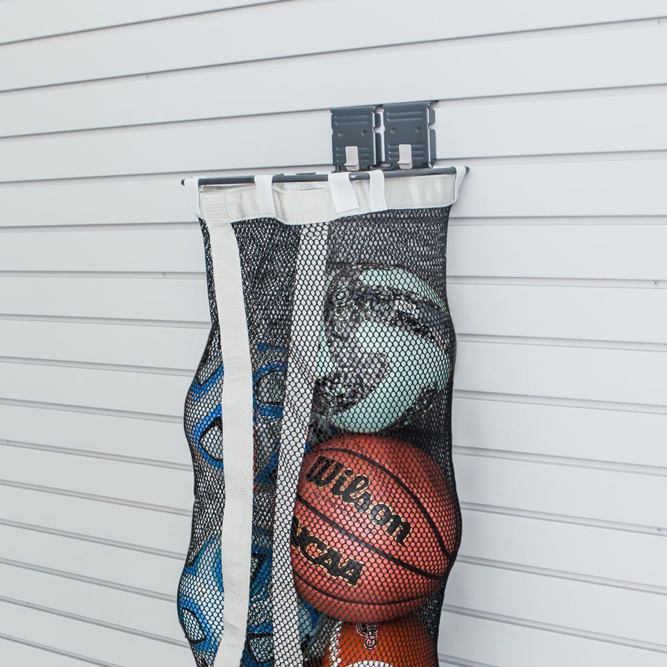 a mesh bag slatwall storage accessory storing sports equipment .