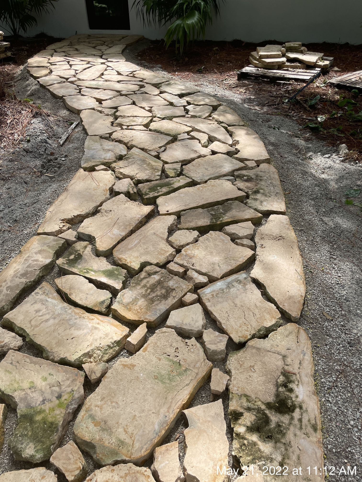 A stone walkway leading to a house.