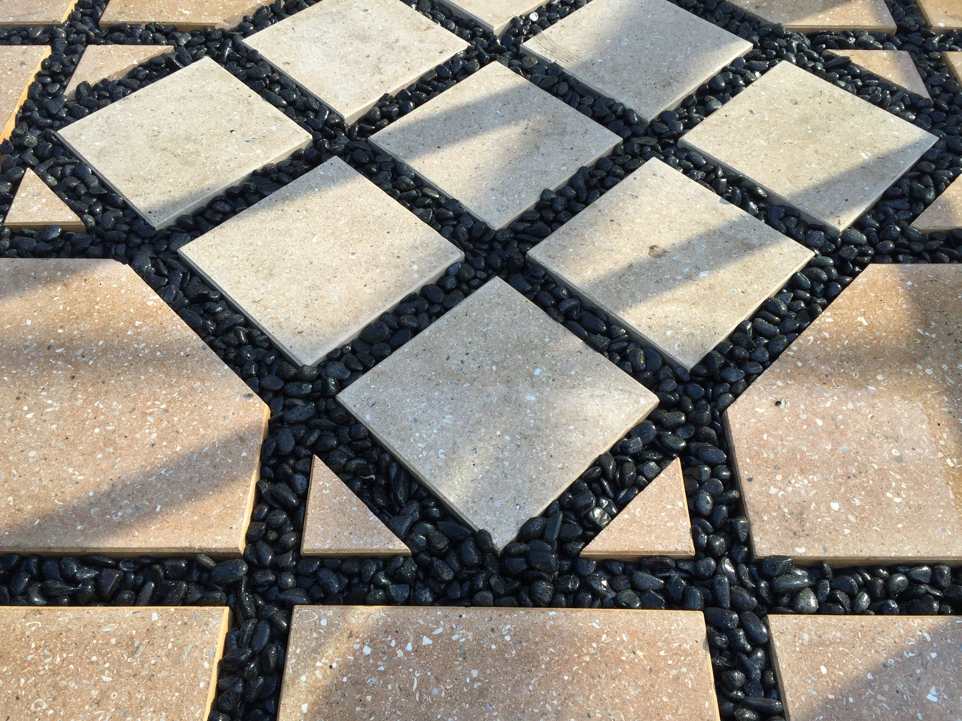 A close up of a brick walkway with a diamond pattern