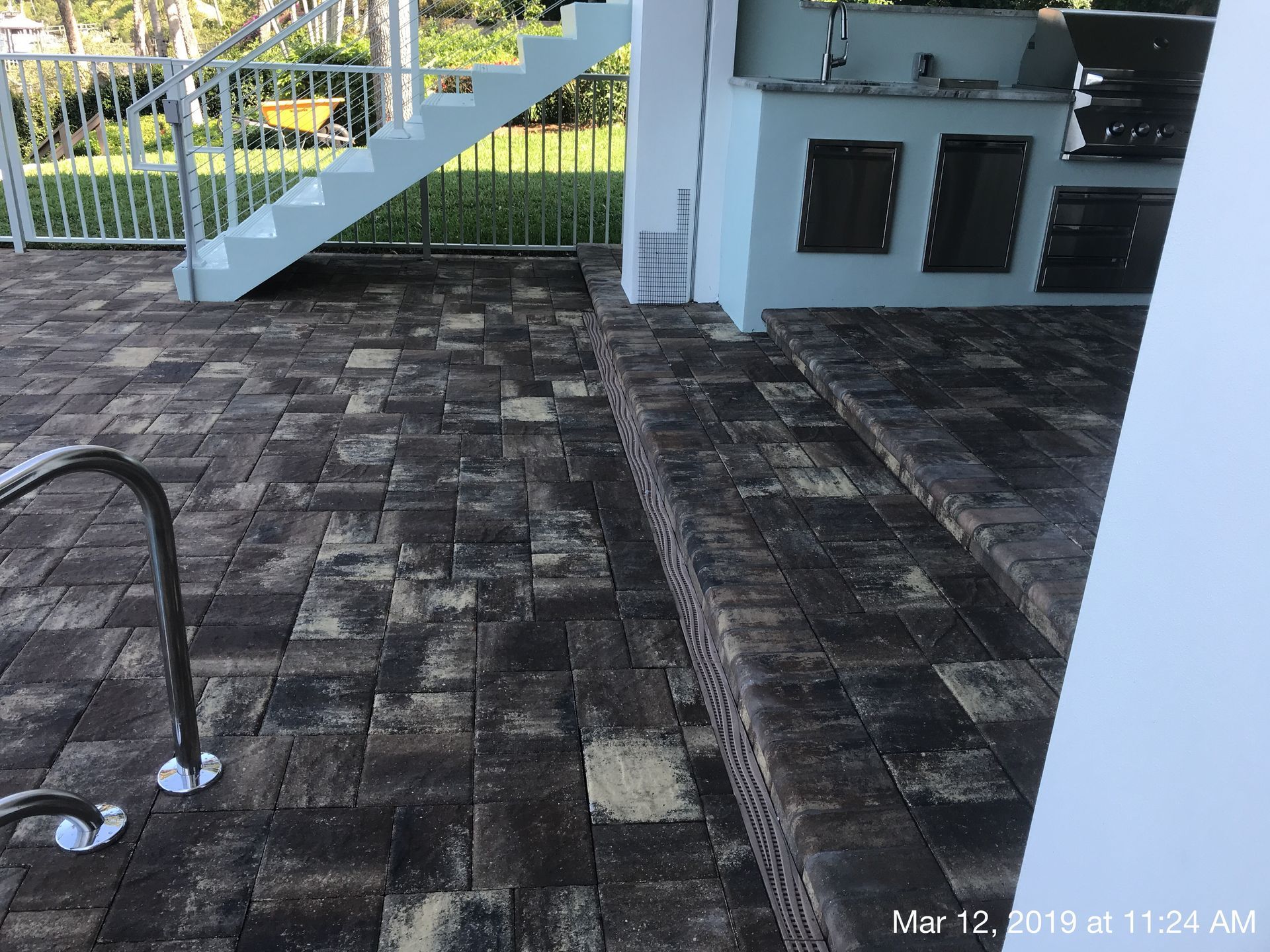 A brick patio with stairs leading up to it
