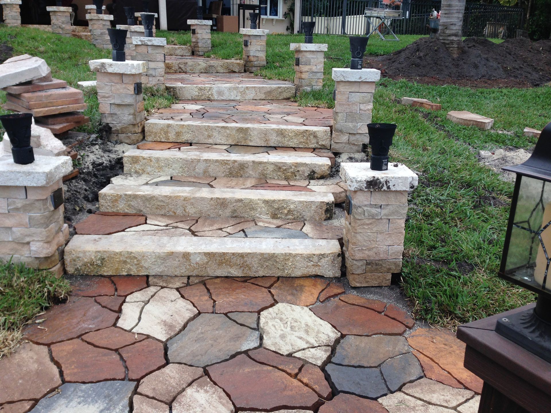A stone walkway with stairs leading up to a house
