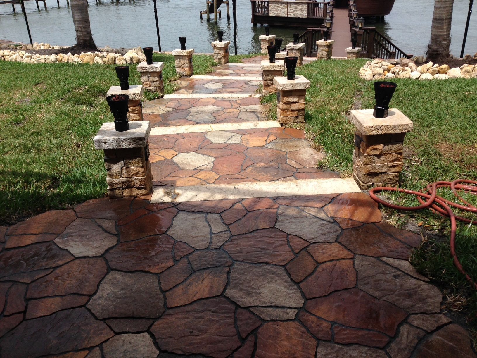 A stone walkway leading to a body of water