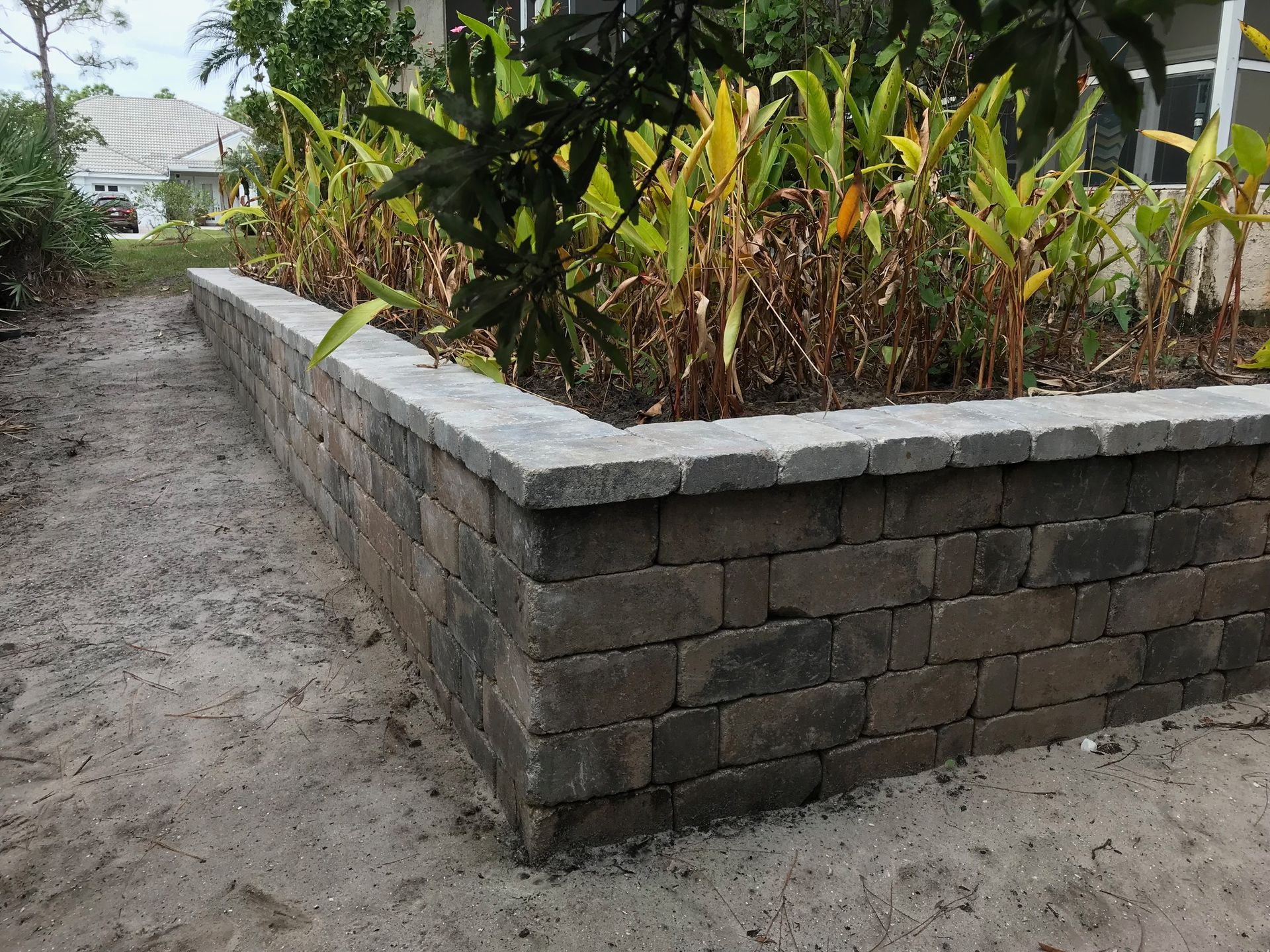 A brick wall with a planter in the middle of it