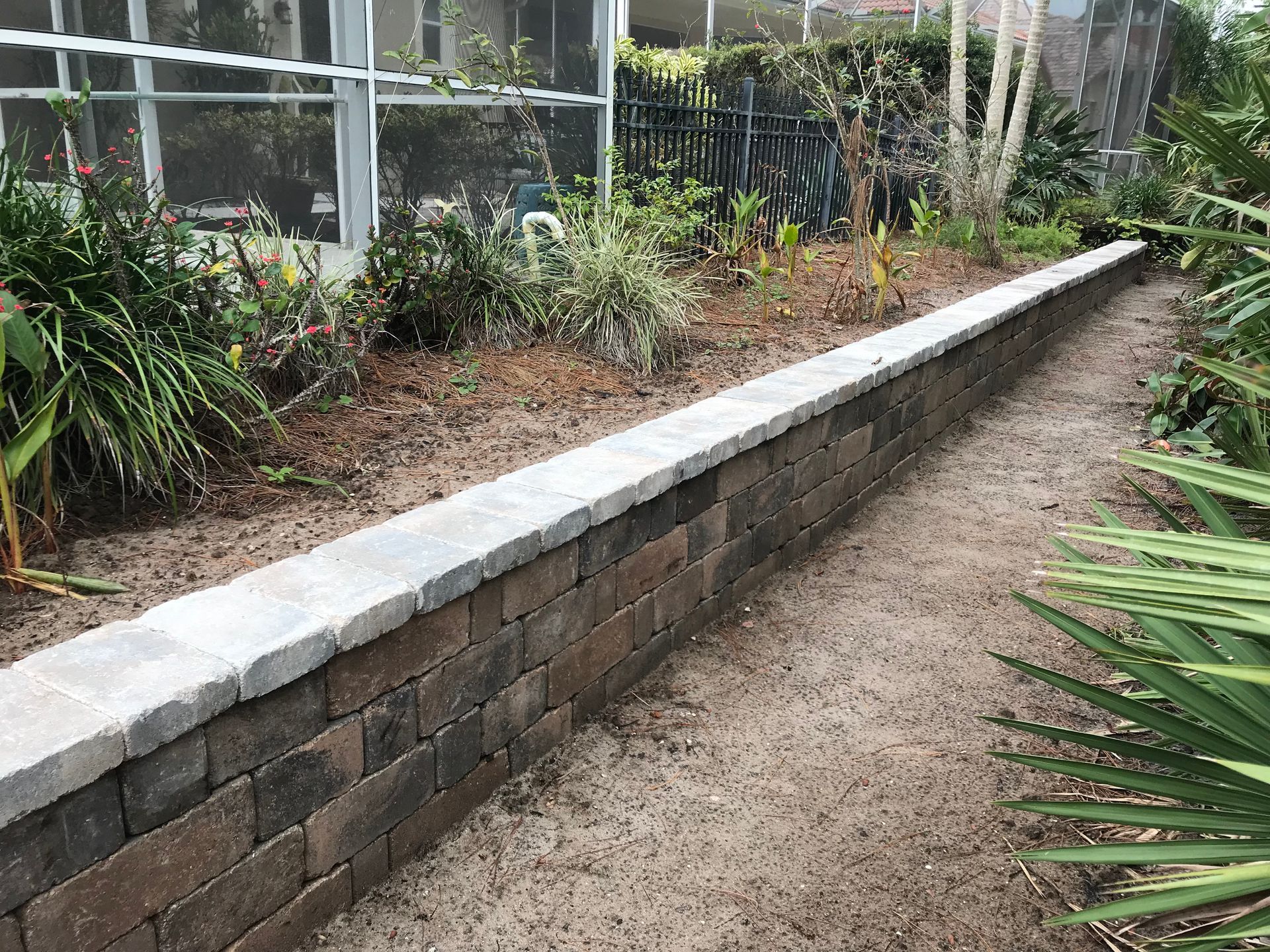 There is a brick wall in the middle of the garden.