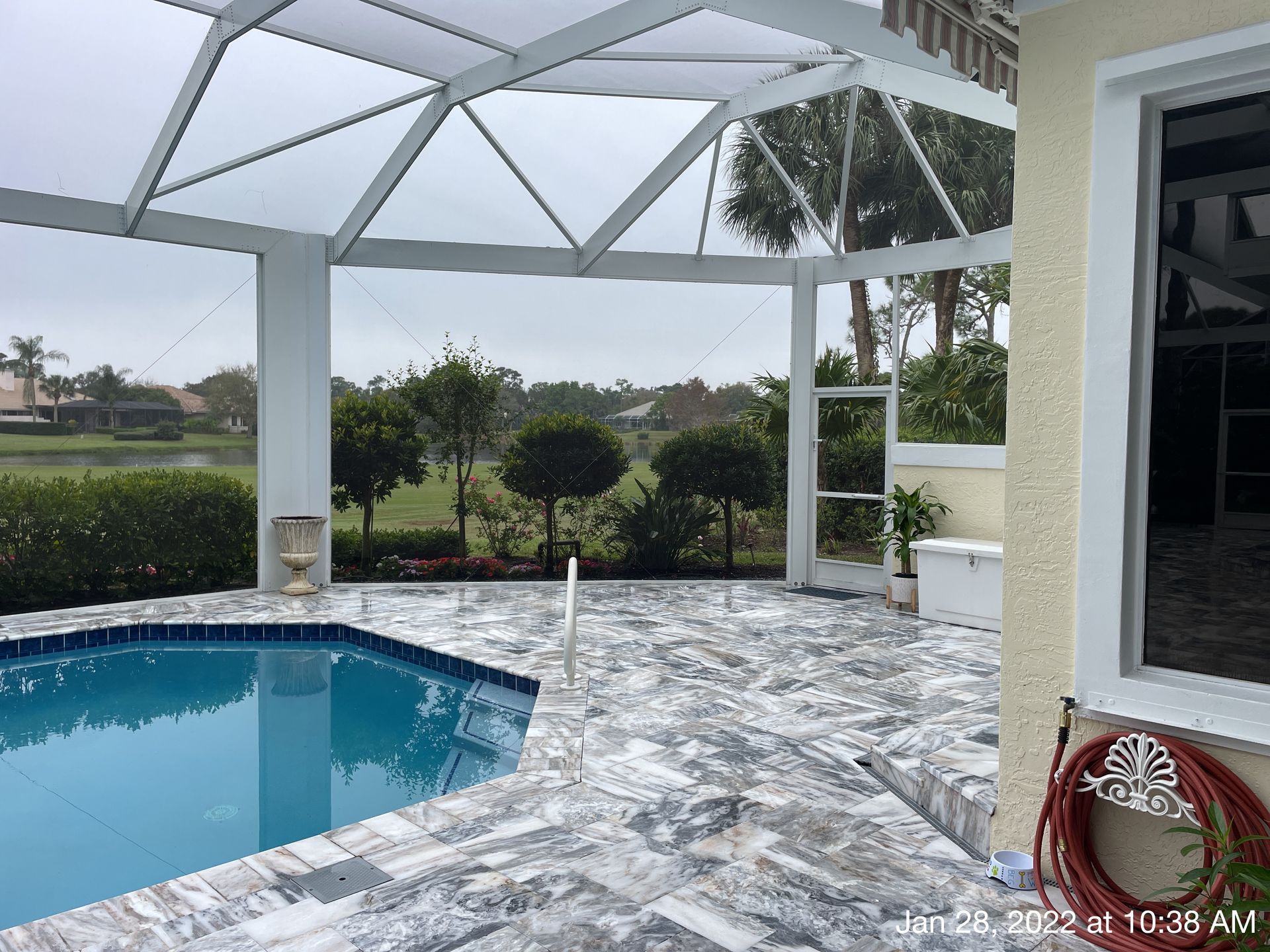 A swimming pool with a screened in area surrounding it