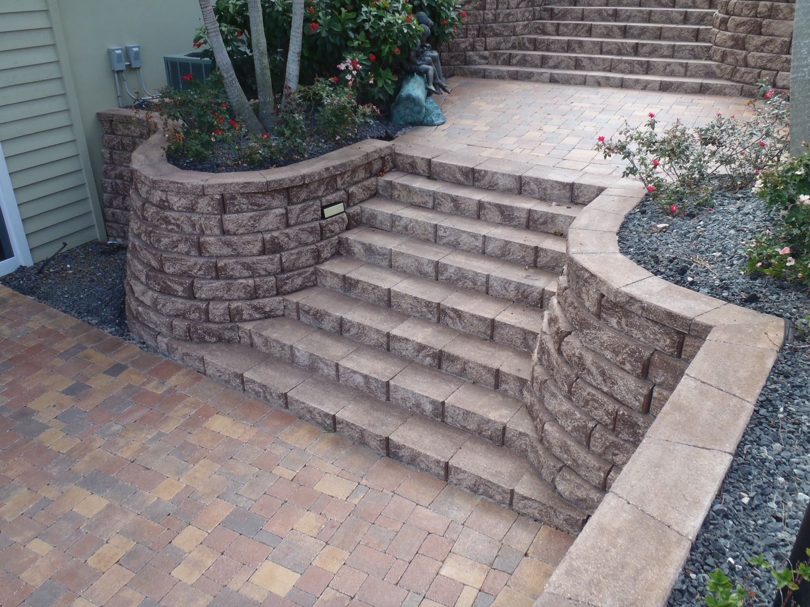 A set of stairs leading up to a brick wall.