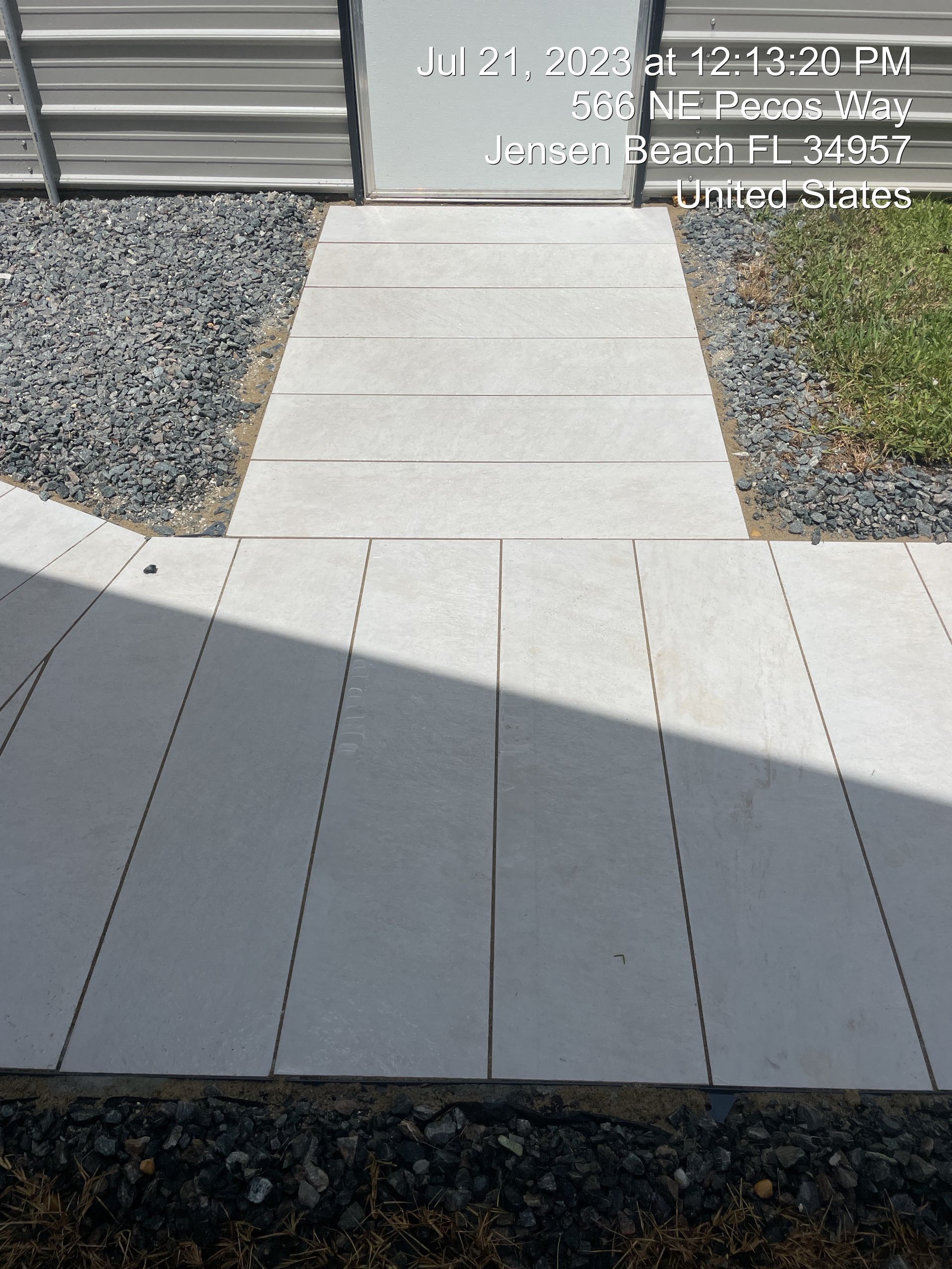A picture of a walkway with a fence in the background