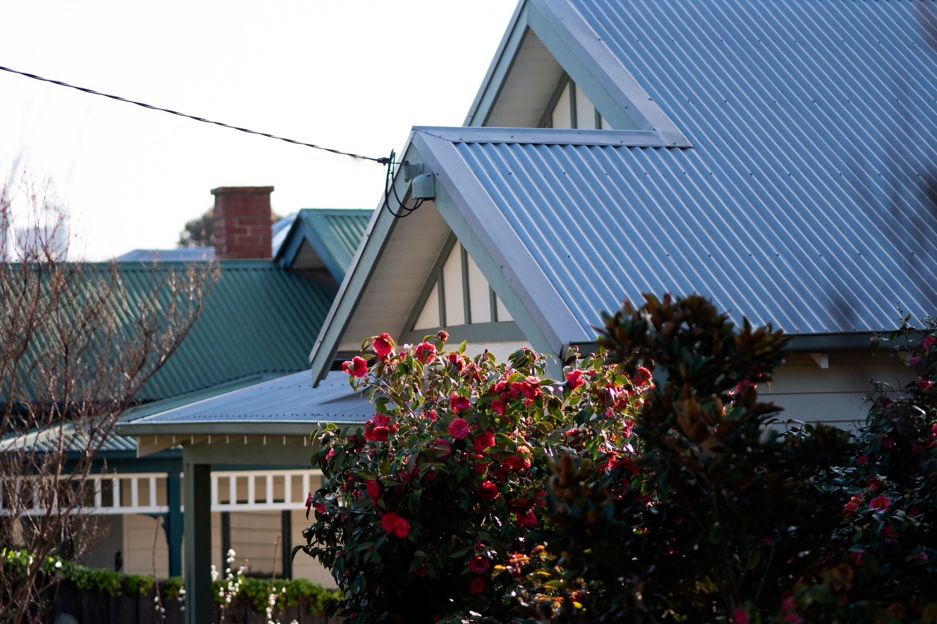 A kitchen with white cabinets, stainless steel appliances, hardwood floors and a large island.