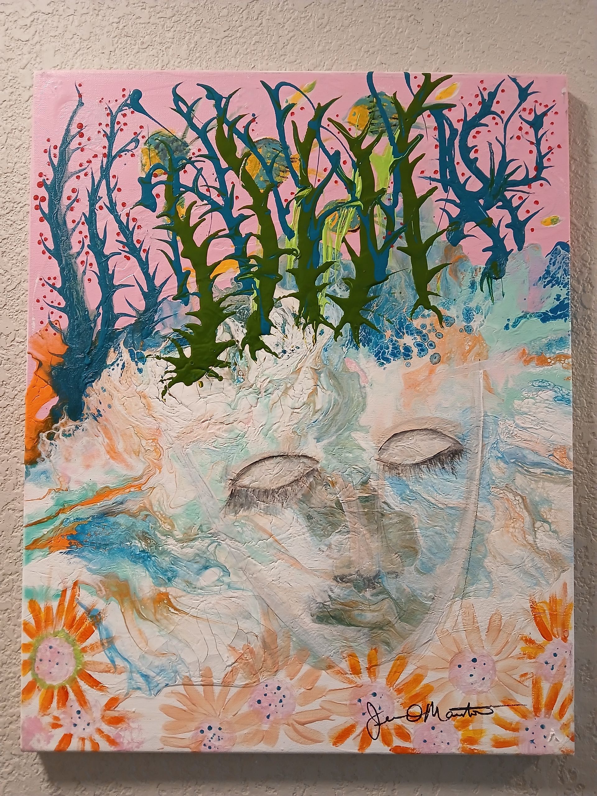 A paint-splattered gray plastic bin with gold, black, white, and brown paint streaks.