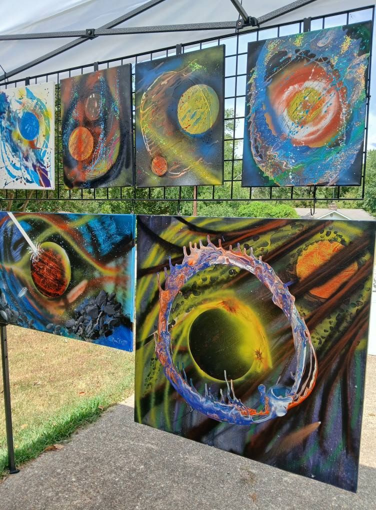 Abstract paintings of celestial objects in an outdoor setting, vibrant colors against dark backgrounds.