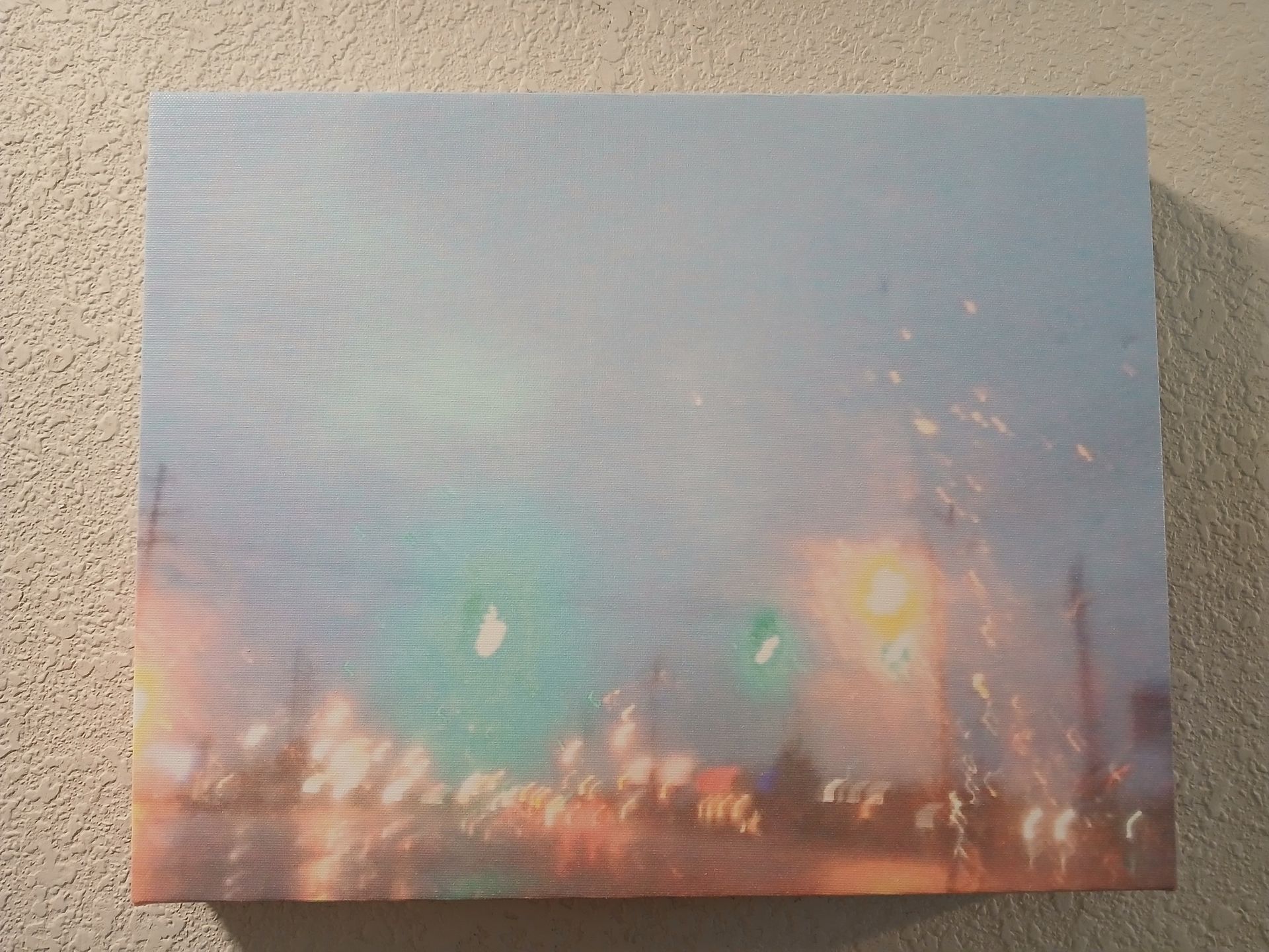 Canvas art with abstract cityscape in pastel colors.