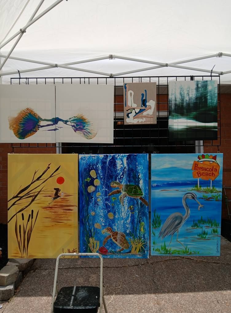 Art display: six paintings of nature scenes, including birds, turtles, and landscapes, at an outdoor art fair.
