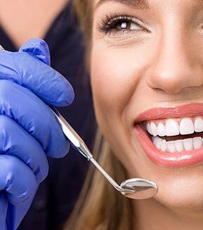 BOTOX® Cosmetic — Dentist Checking Teeth of Patient in Mansfield, OH