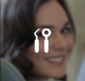 A close up of a woman 's face with a dental icon in the foreground