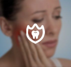 A woman is holding her face in pain because of a toothache.