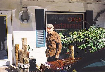 Raymond Proffitt in front of his house