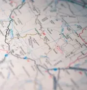 Close-up of a printed road map with red and blue route lines and place names