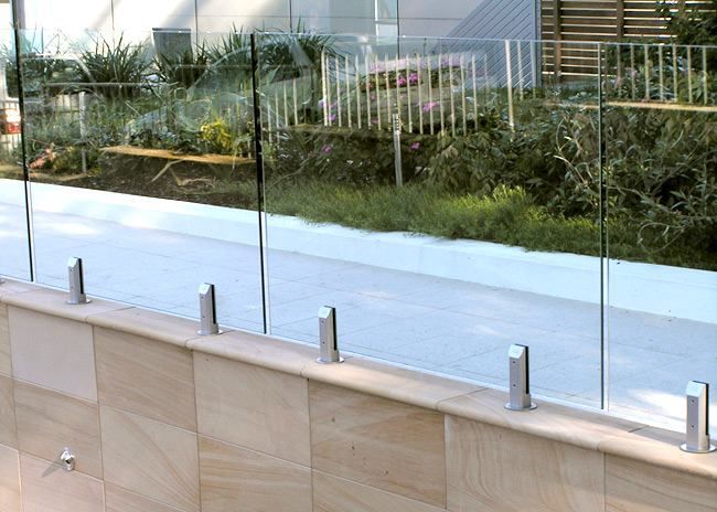 Glass Fence on a Stone Wall — The Fence Place in Kawana, QLD
