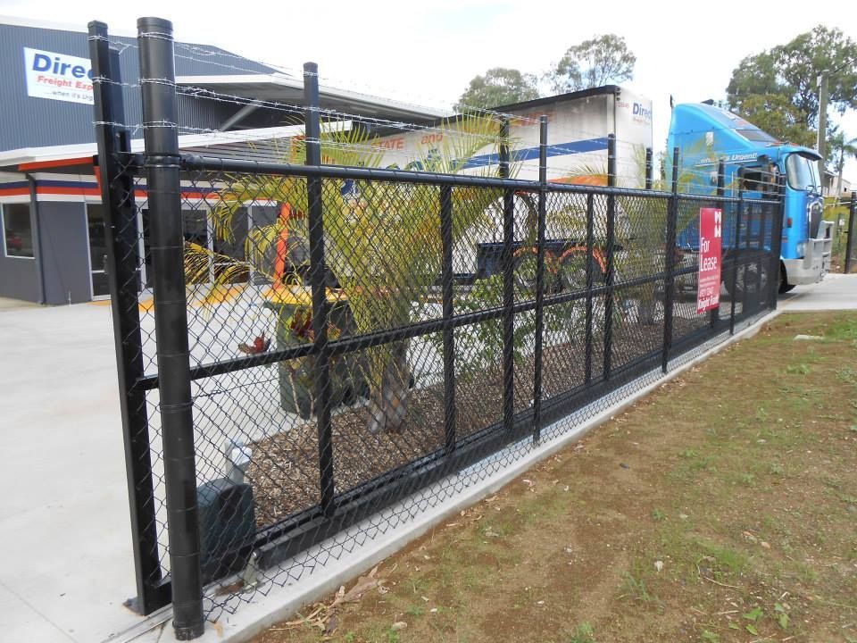 Black Chain-link Sliding Gate at a Business Entrance — The Fence Place in Kawana, QLD
