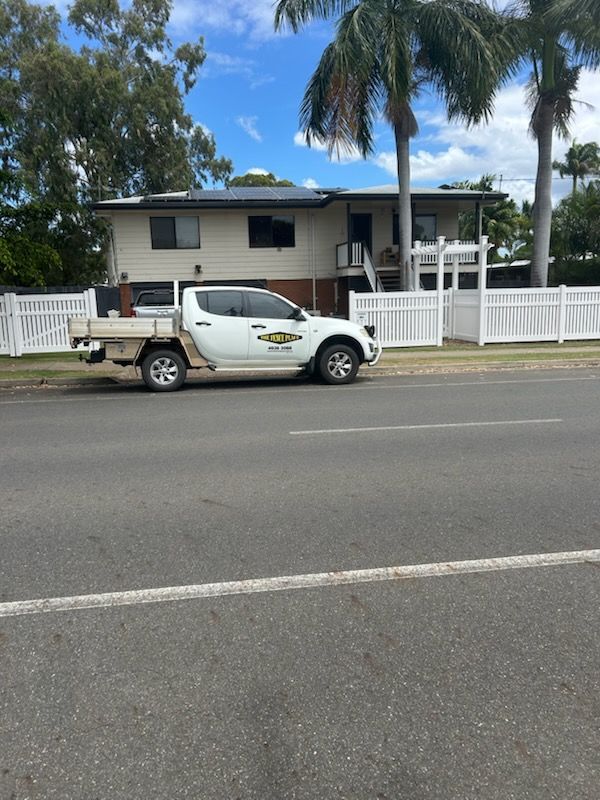 White Truck Parked in Front of a Two-story House With a White Fence — The Fence Place in Port Kawana, QLD