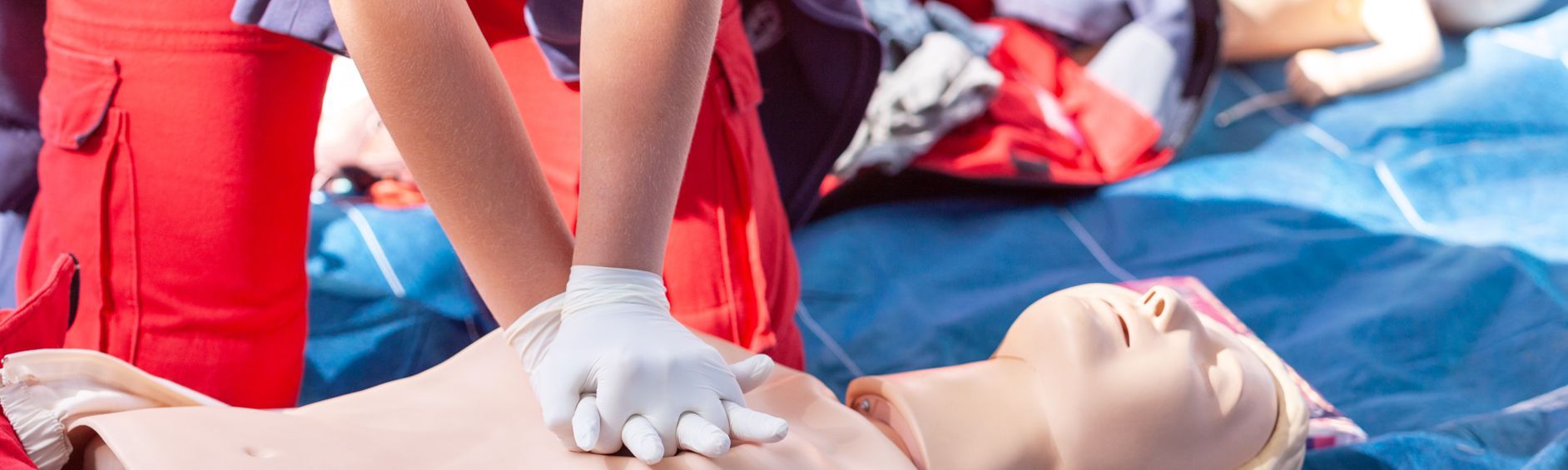 A person is giving a heart massage to a mannequin.