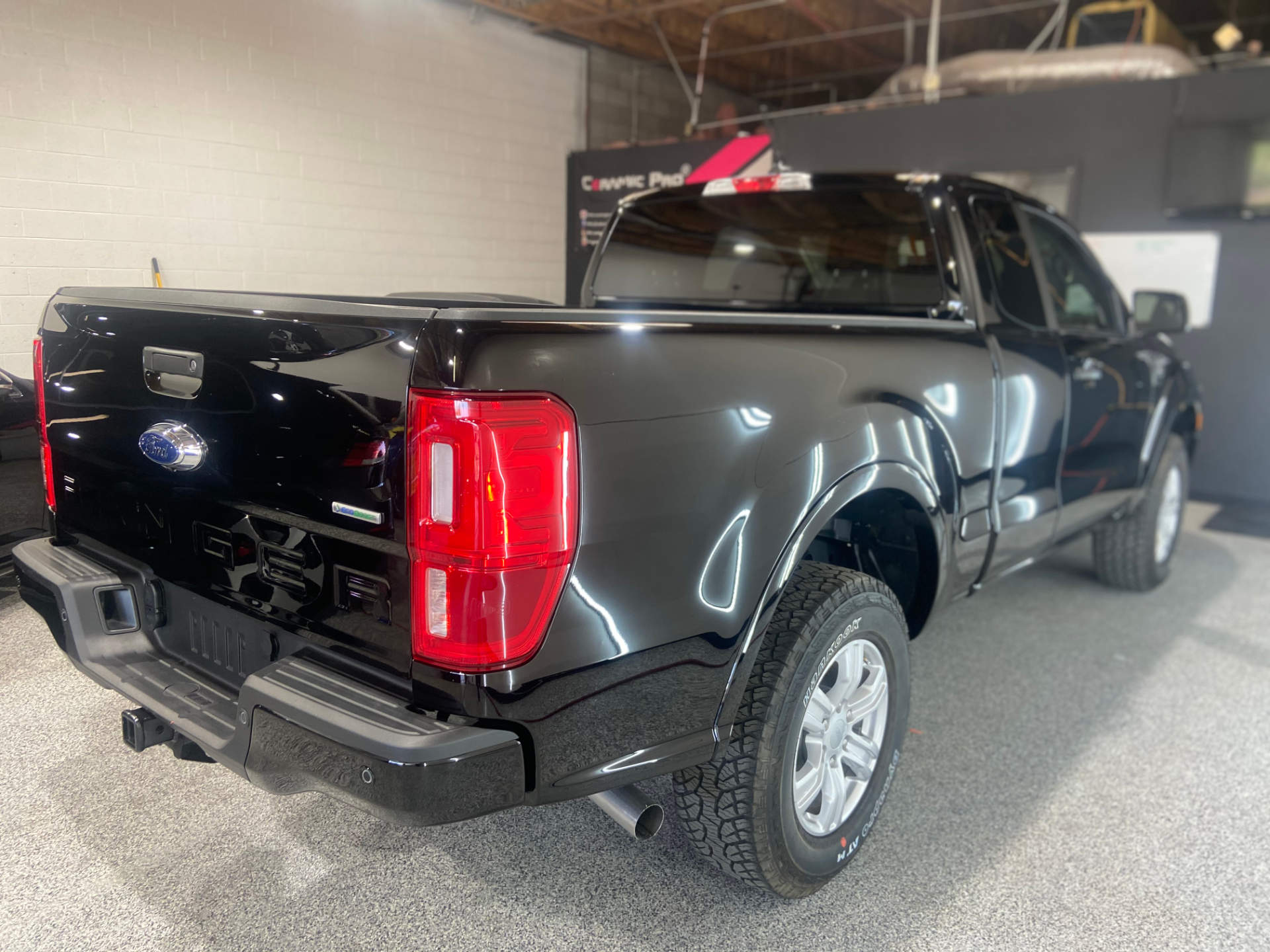 glossy black ford ranger in the auto this world shop