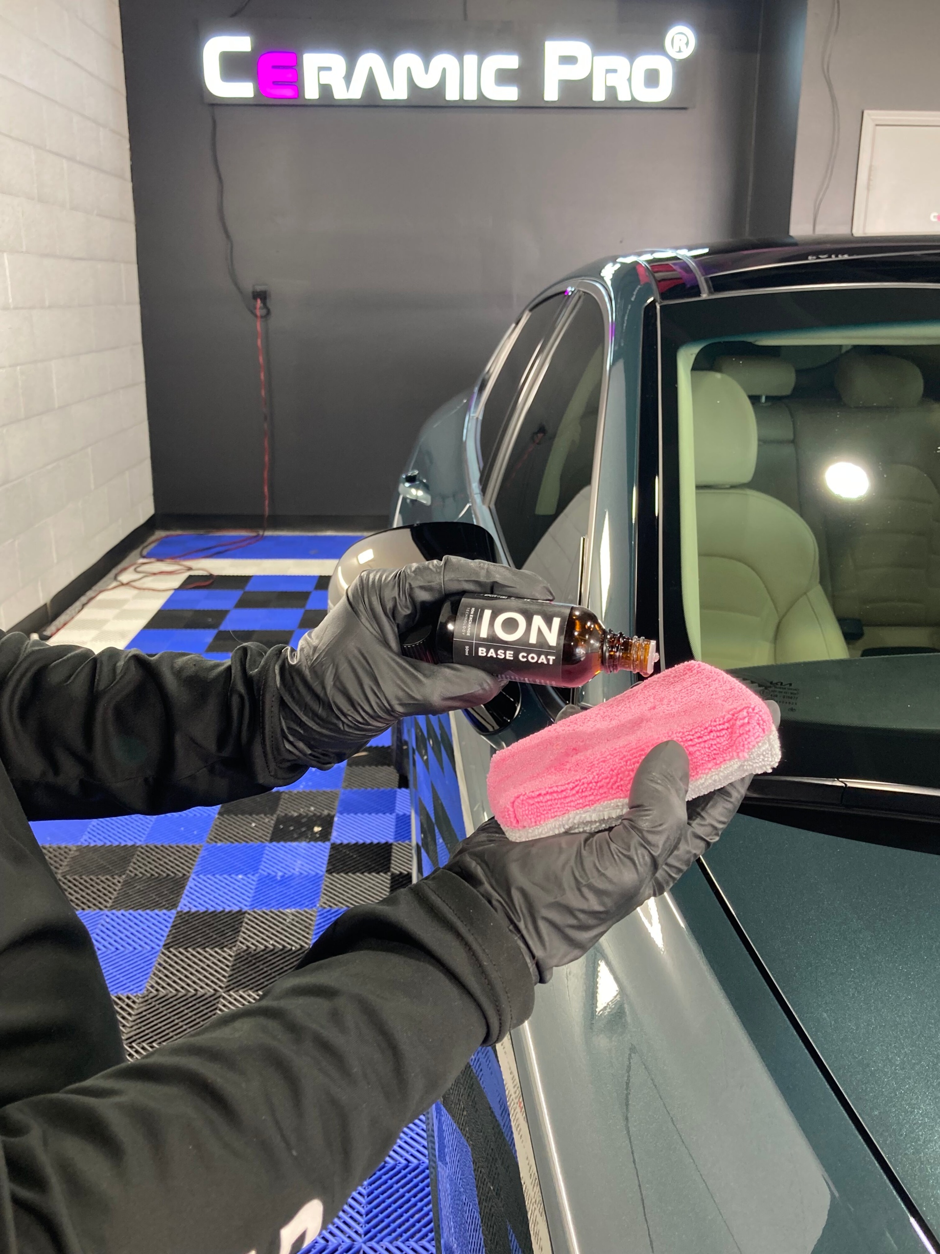 car detailing expert applying ion base coat