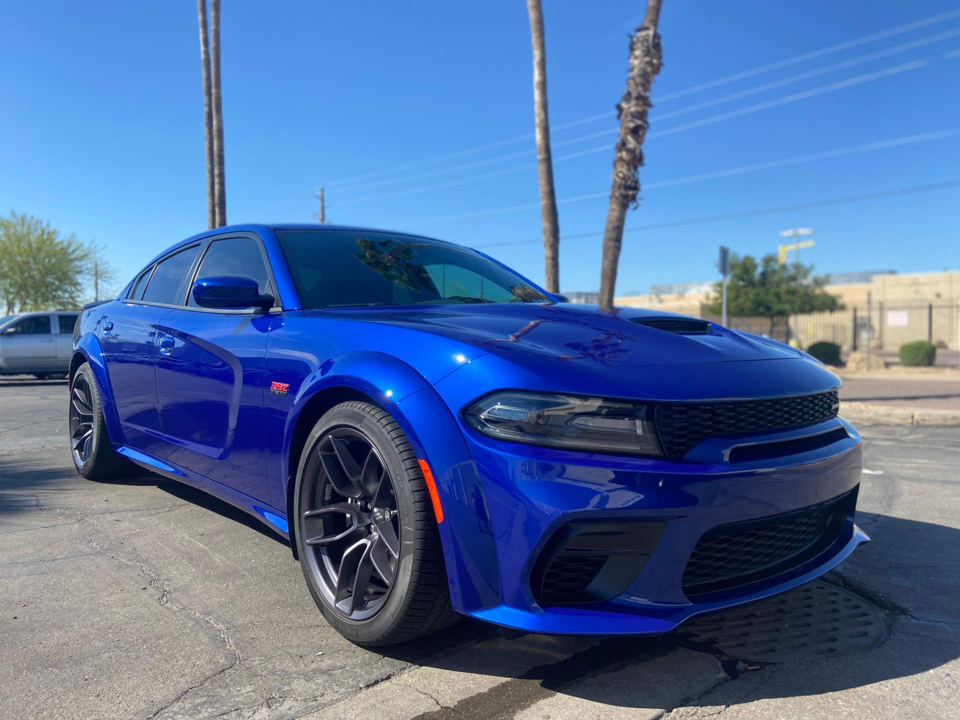 slick blue charger parked at auto this world lot