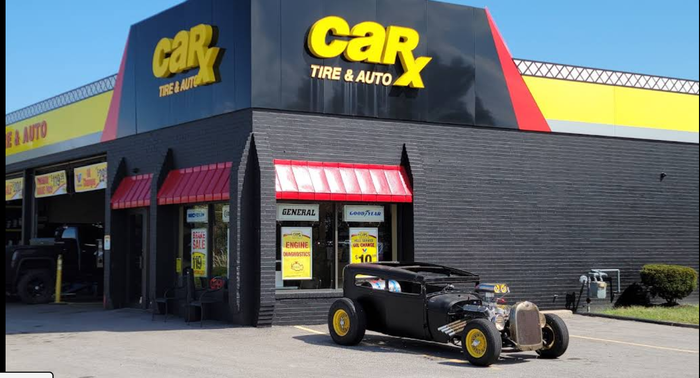 CarX Tire & Auto shop with black hot rod out front.