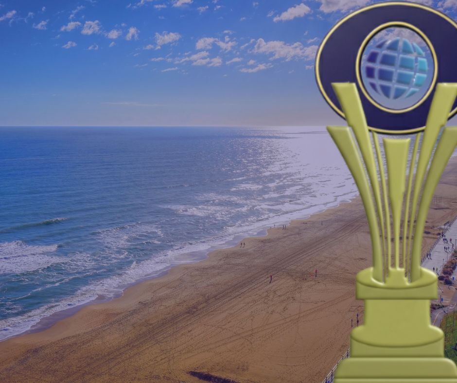 Beach scene with ocean waves and a golden trophy featuring a globe.