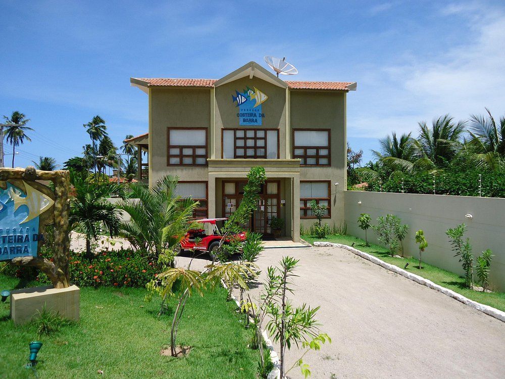 Um jipe está estacionado em frente a um grande edifício