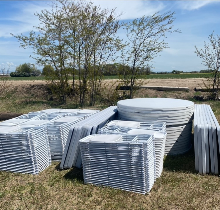Tables and chairs stacked for set up