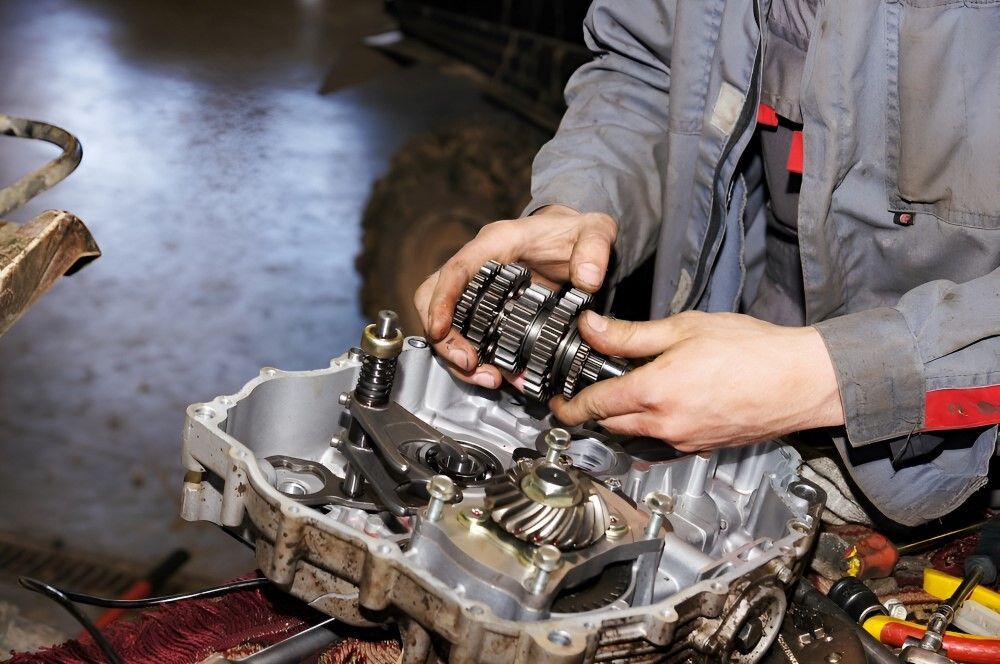 A Man is Working on a Car Engine in a Garage — TeeJay Mechanical Repairs In Beard, ACT