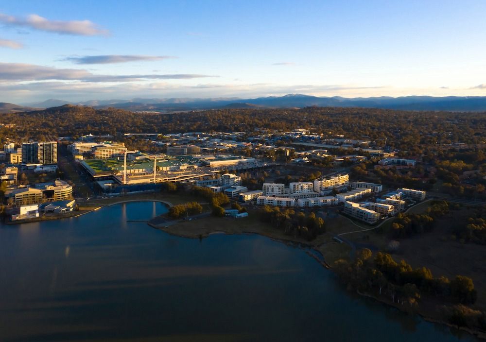 An Aerial View of a City With a Lake and Mountains in the Background — TeeJay Mechanical Repairs In Beard, ACT
