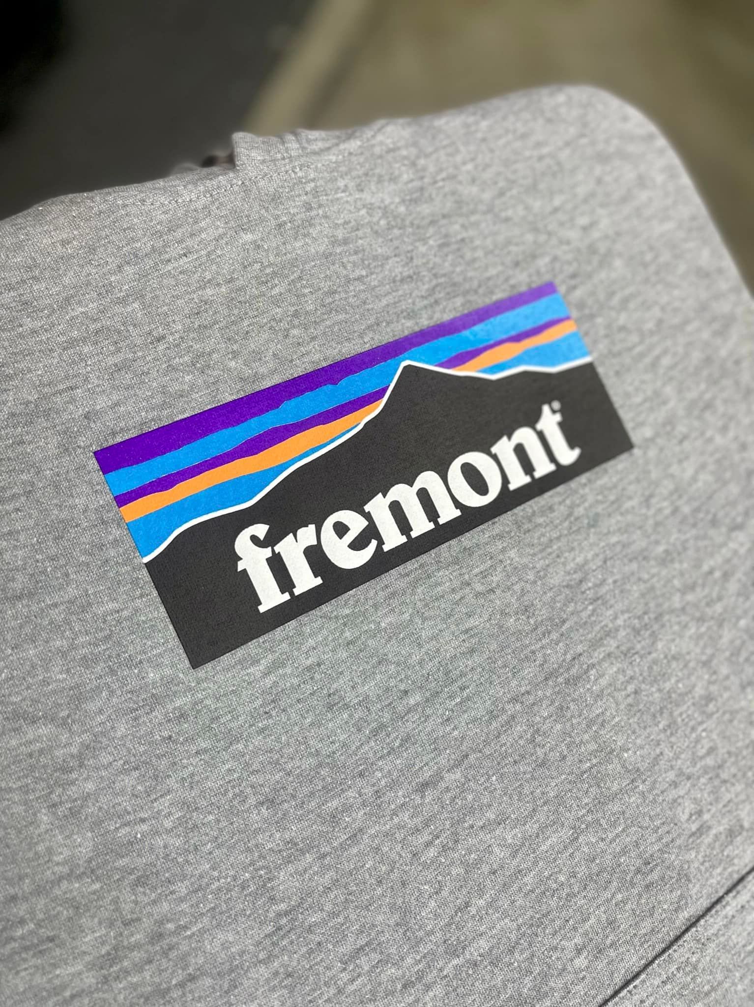 A close up of a patagonia logo on a gray shirt.