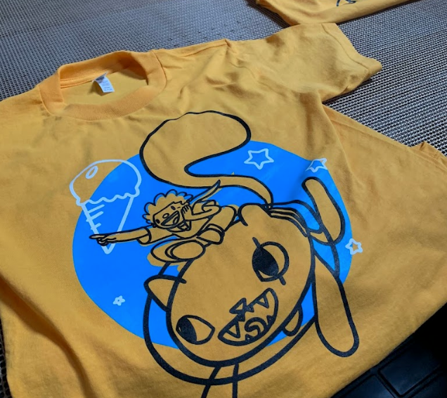 A yellow t-shirt with a cat holding an ice cream cone