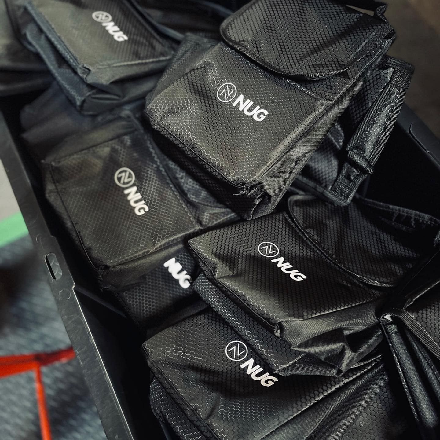 A bunch of black bags with the word nug on them