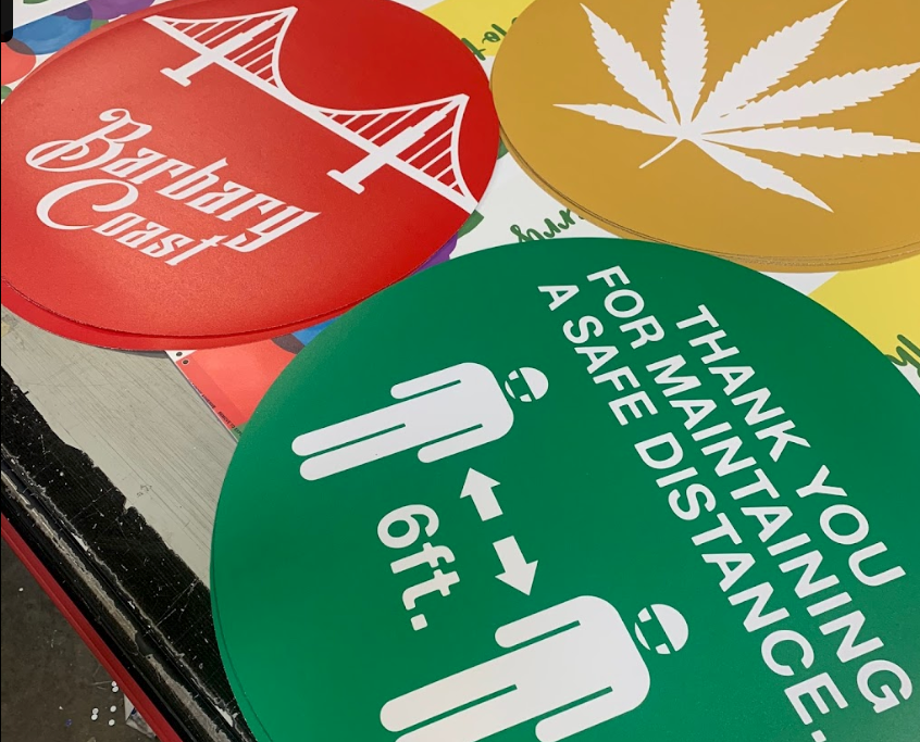 A green sign says thank you for maintaining a safe distance