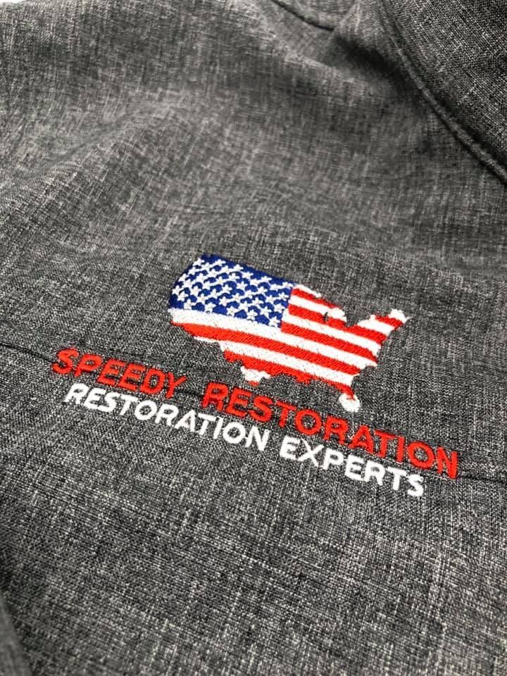 A close up of an embroidered logo on a hoodie.