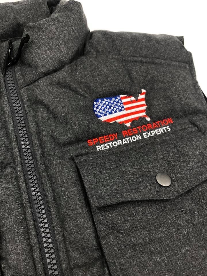 A close up of a vest with an american flag embroidered on it.