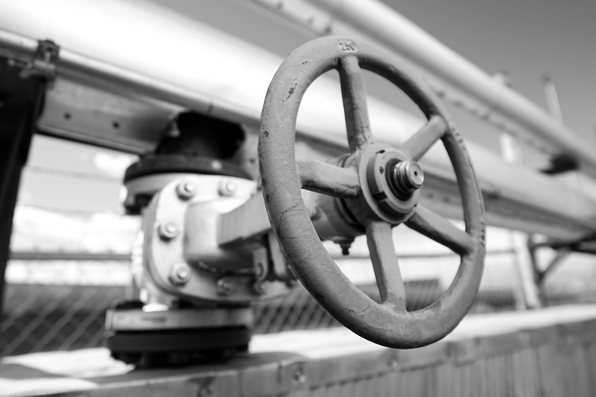 A row of orange and white traffic cones on a blue track.