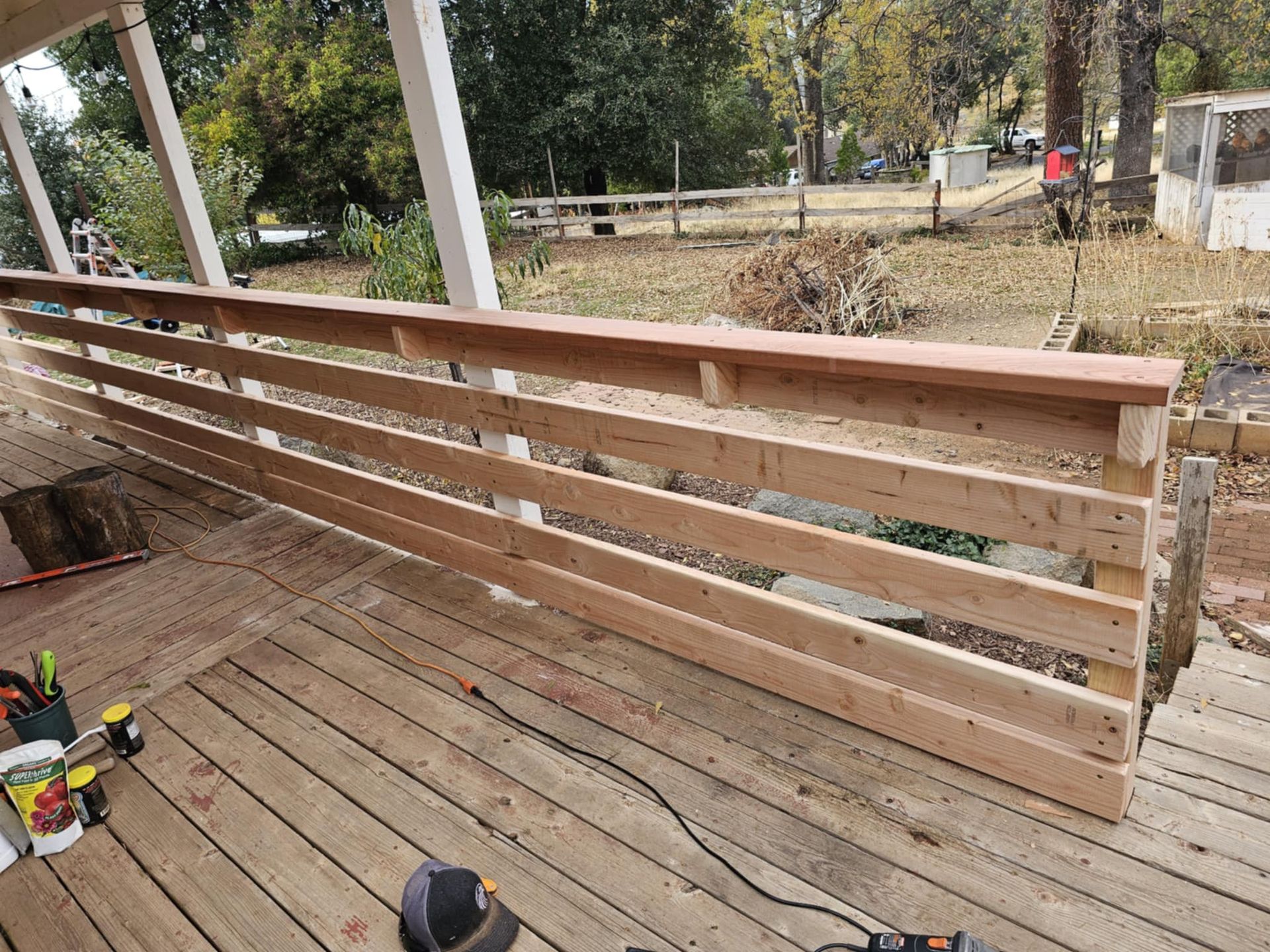 A wooden railing is being built on a deck.