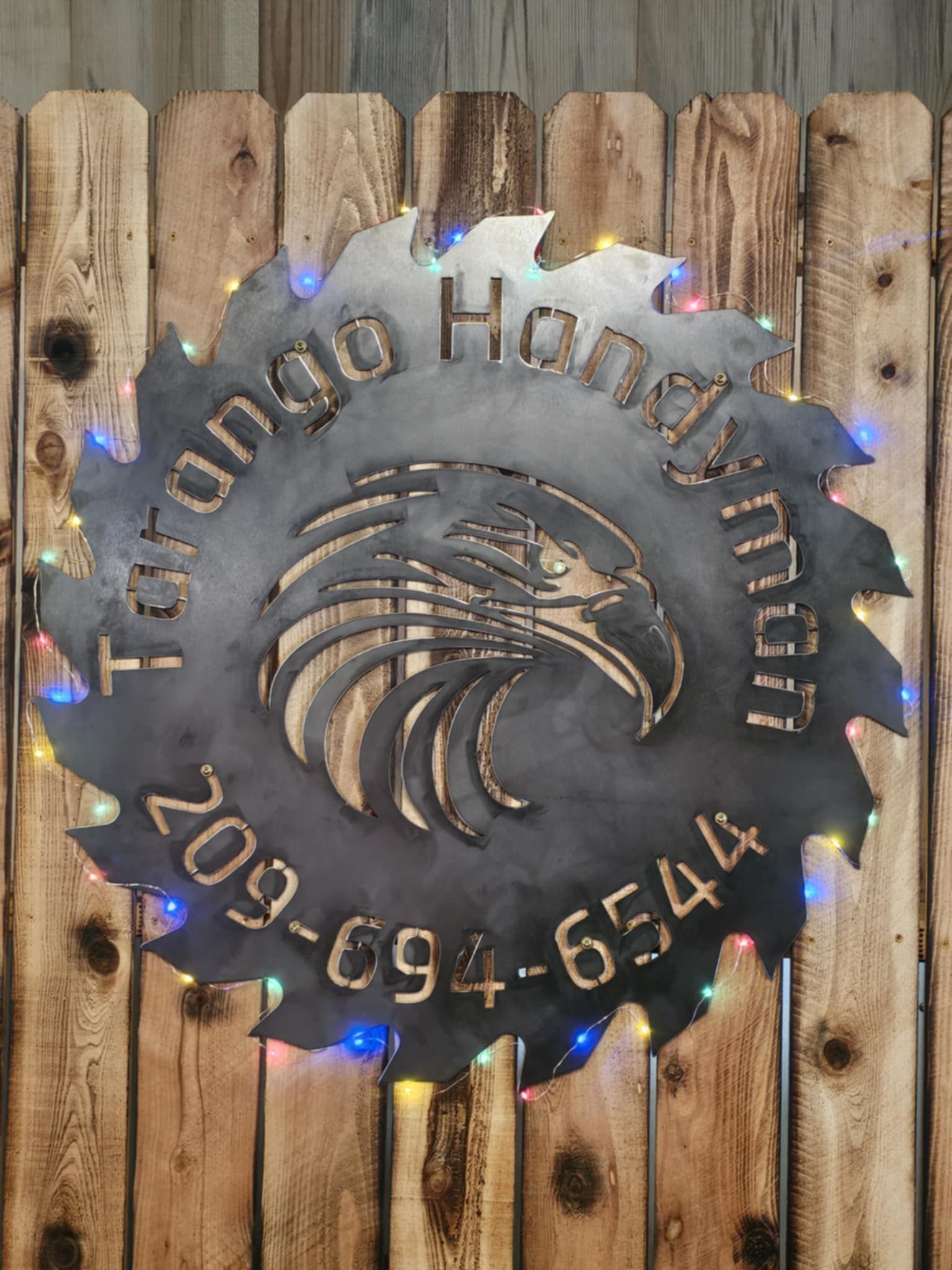 A sign on a wooden fence that says toronto handyman