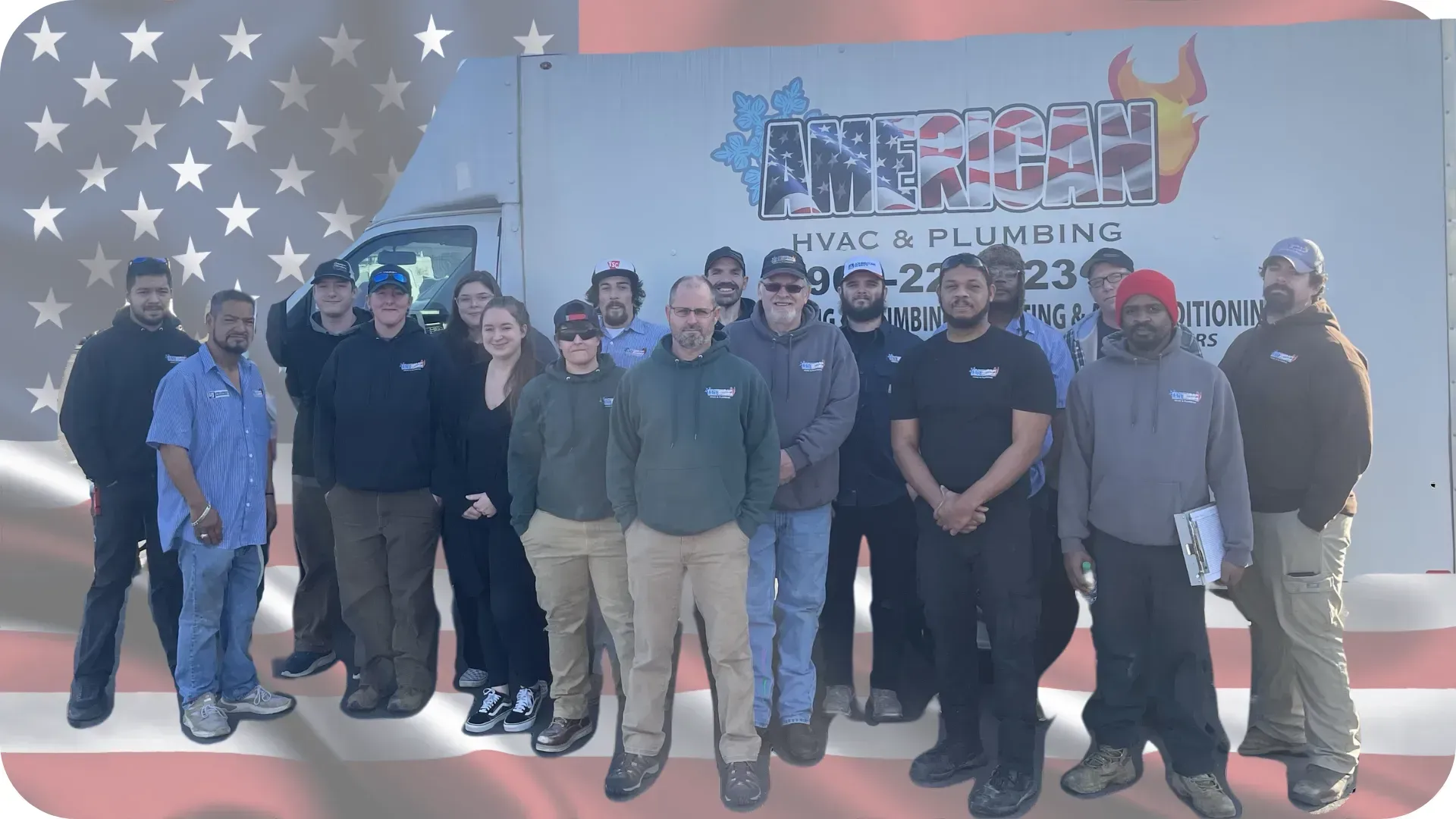 Group of people standing in front of a company van with American flag background.