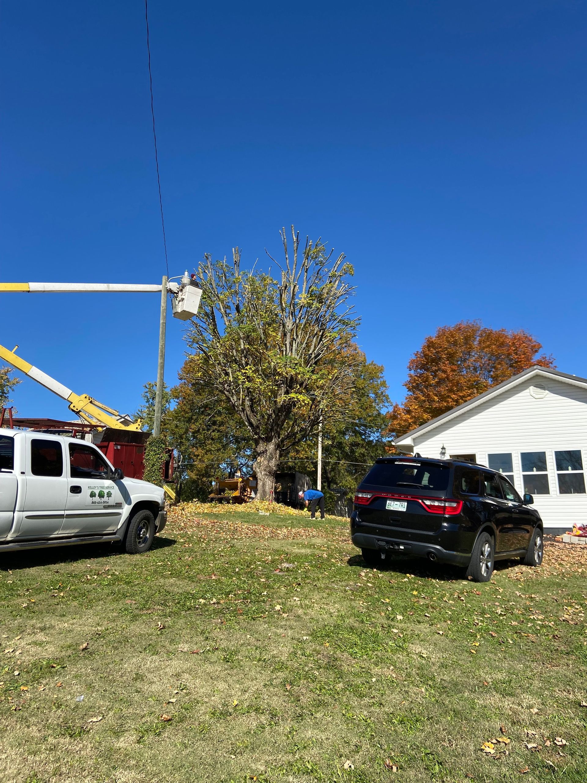 A truck and a suv are parked in front of a house.