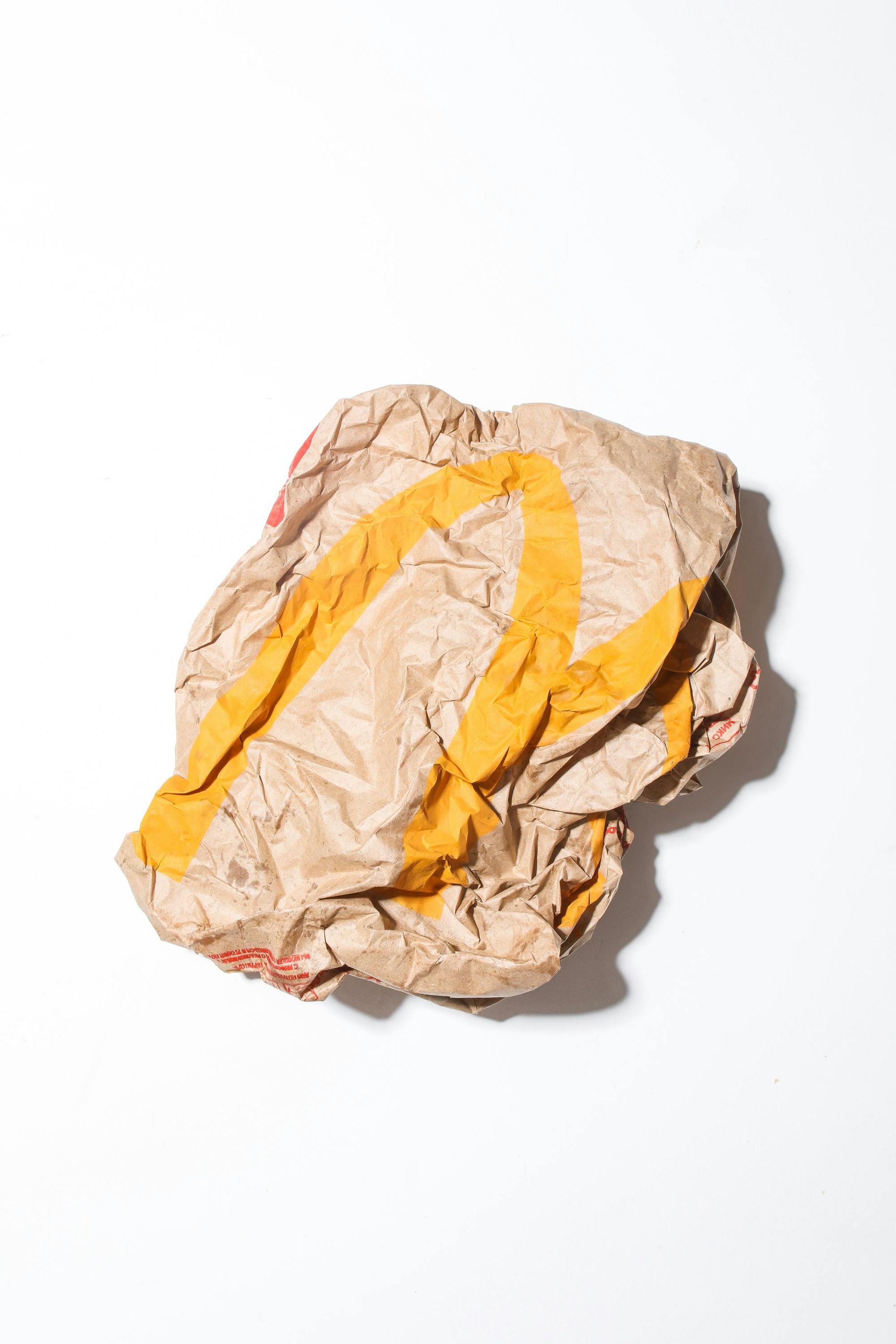 A piece of crumpled brown paper with a yellow stripe on it.