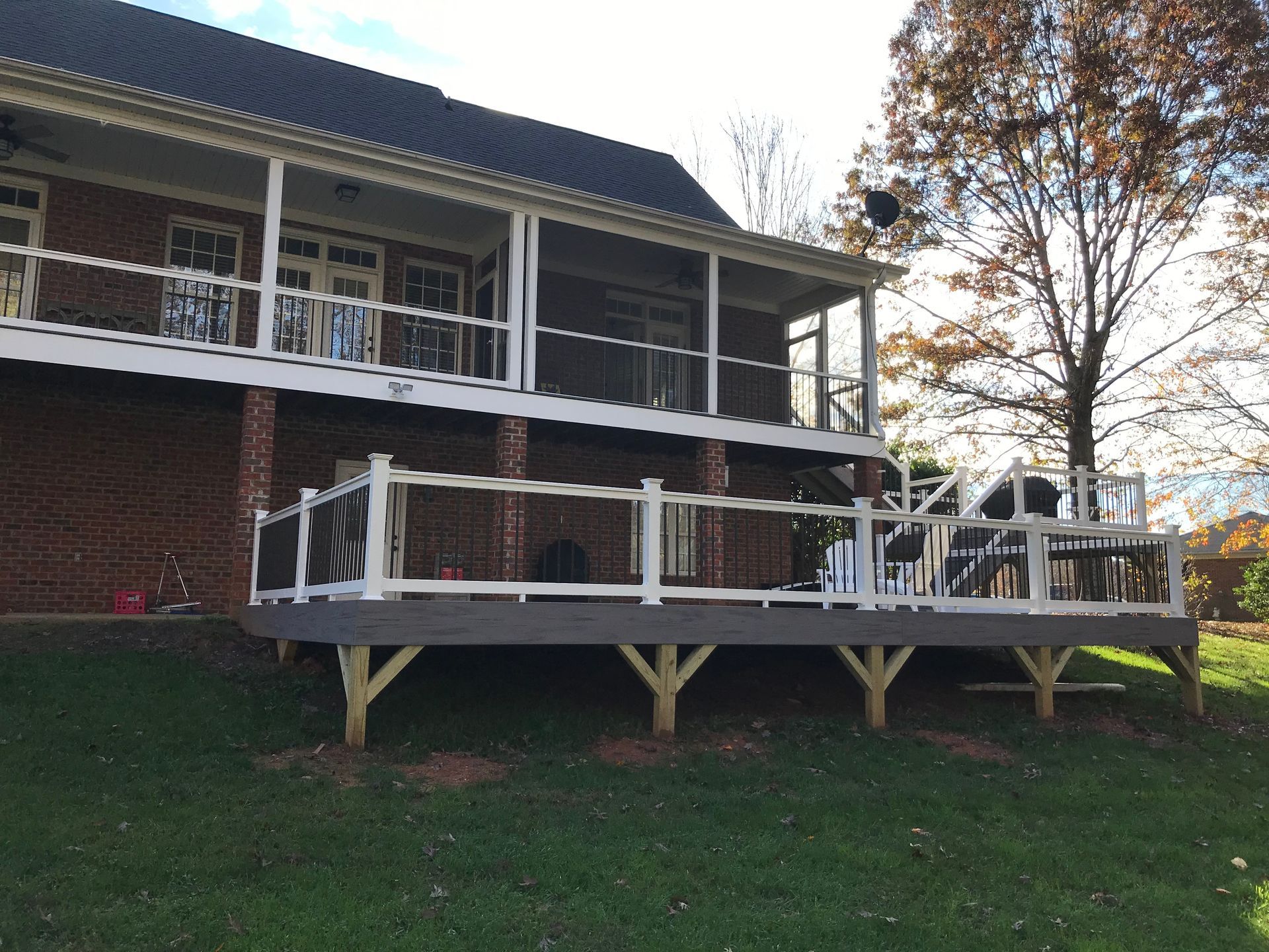 A large house with a large deck in front of it.